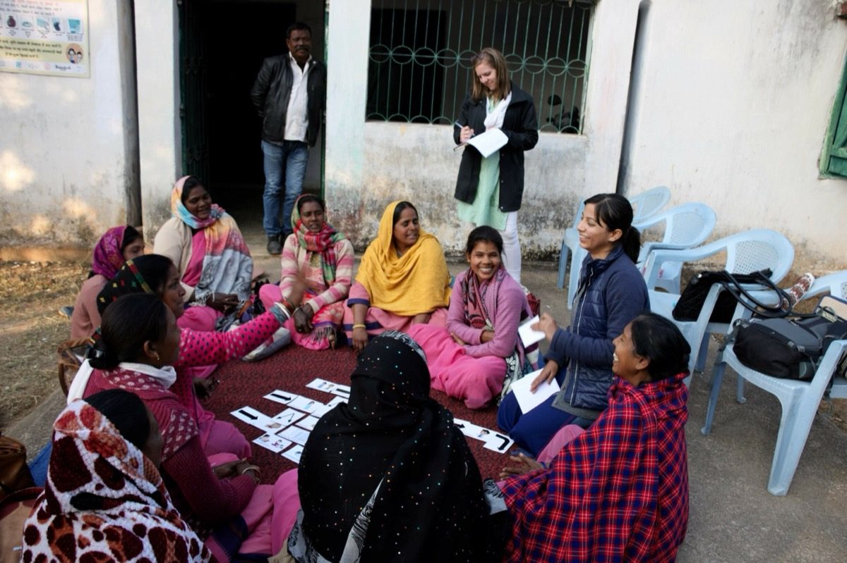 Dimagi researchers running a card-sorting session with community members during field research