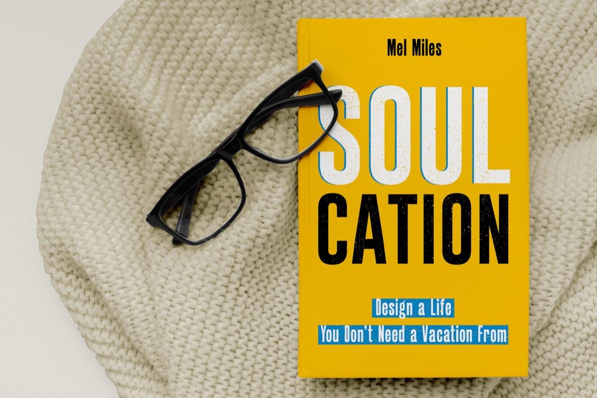 A copy of the book Soulcation resting on a table in a calm home setting.